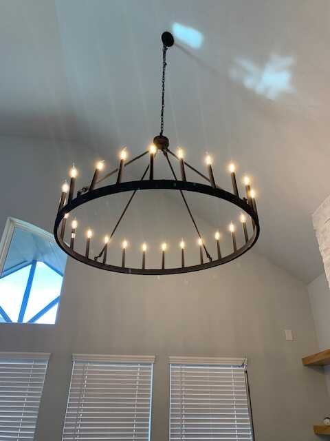 Wagon-wheel chandelier installed on a vaulted ceiling in a San Antonio home