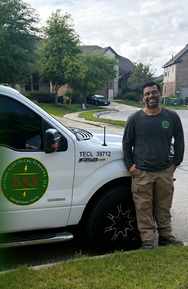 Owner of Beyond Electrical Services, LLC standing beside the company truck